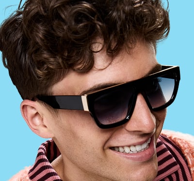 A smiling man wearing large black Zenni square sunglasses with gold accents.